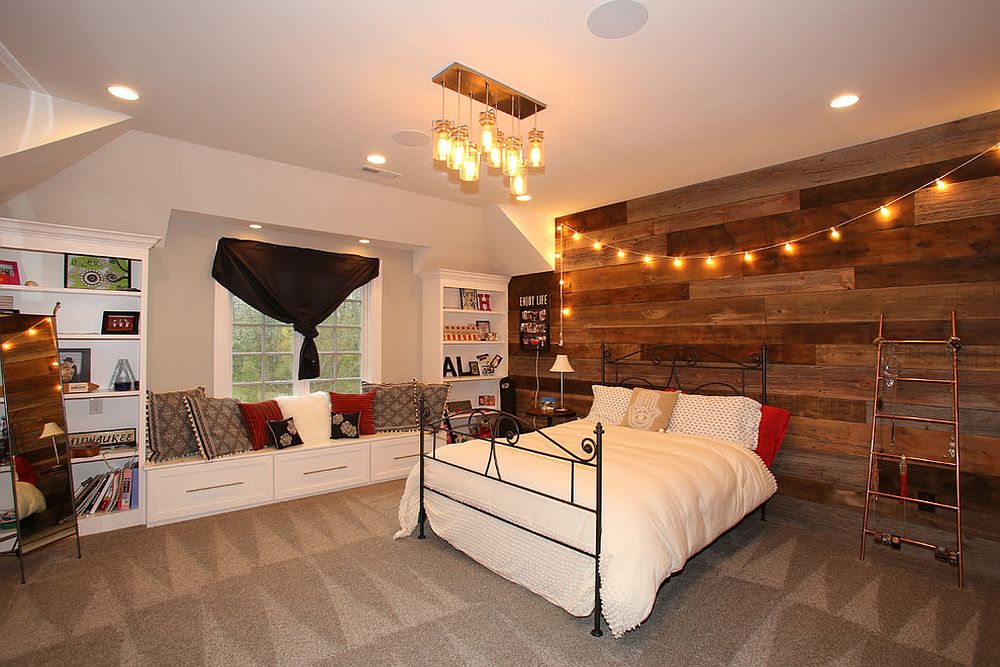 String lights bring warmth to the rustic bedroom with wooden accent wall