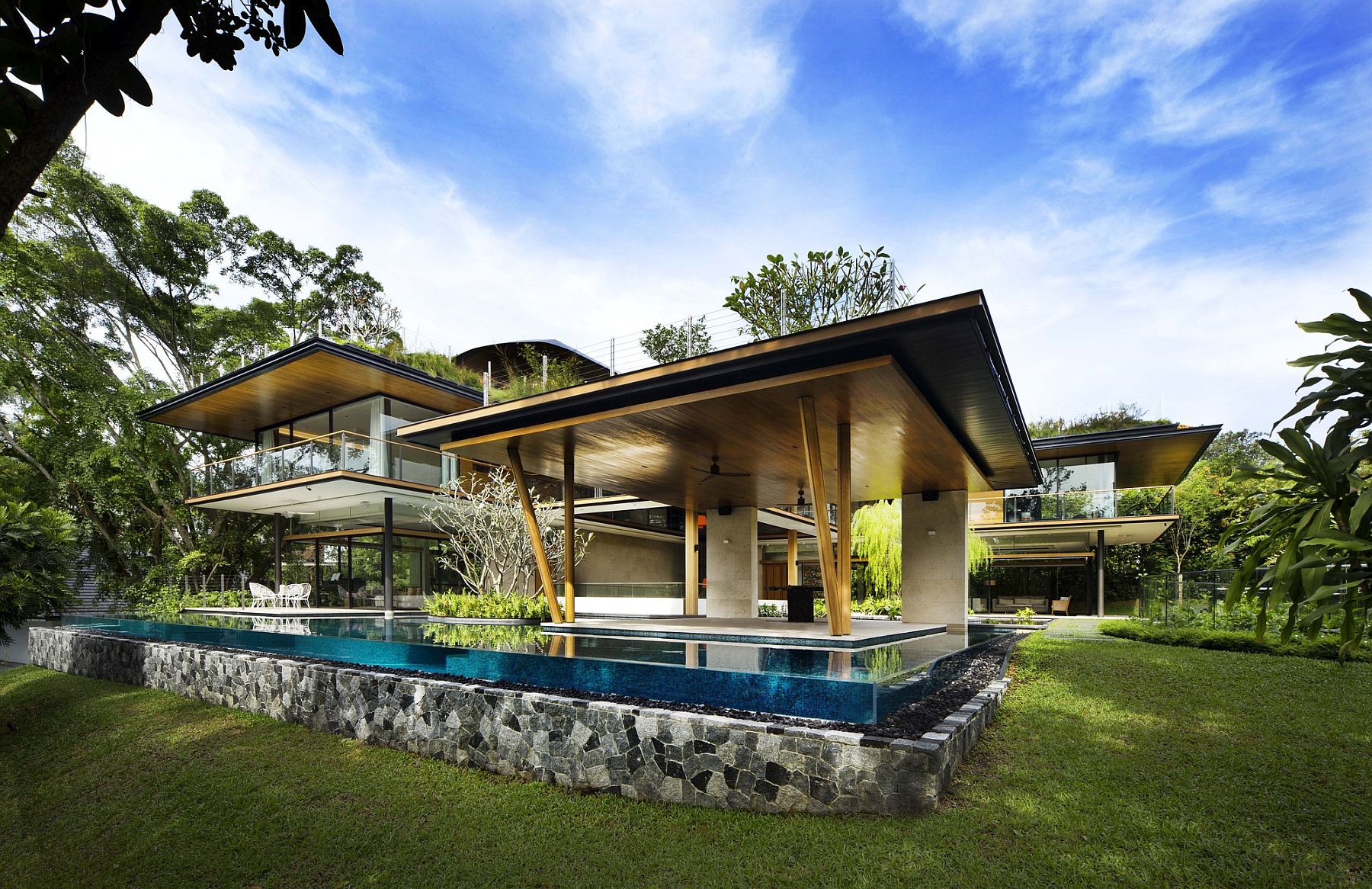 Stunning contemporary house with plenty of greenery and a natural pond and pool