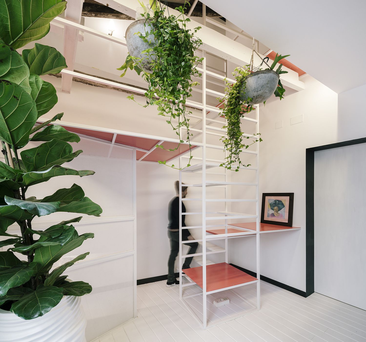 Versatile staircase leading to the loft acts as a work desk, display, low table and a smart sitting area