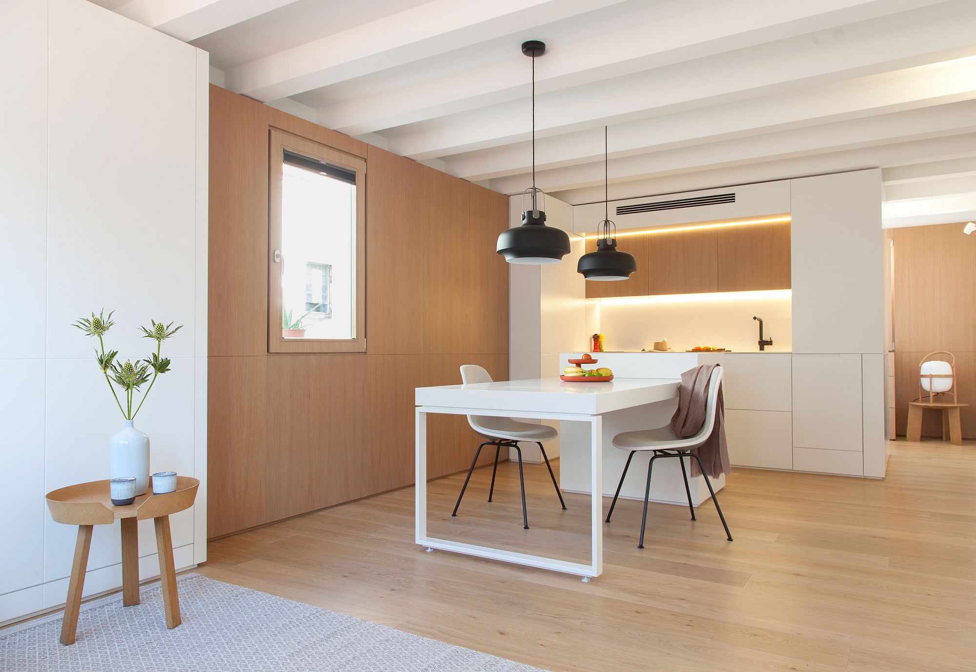 White and wood create a beautiful and space-savvy interior for the tiny Barcelona apartment