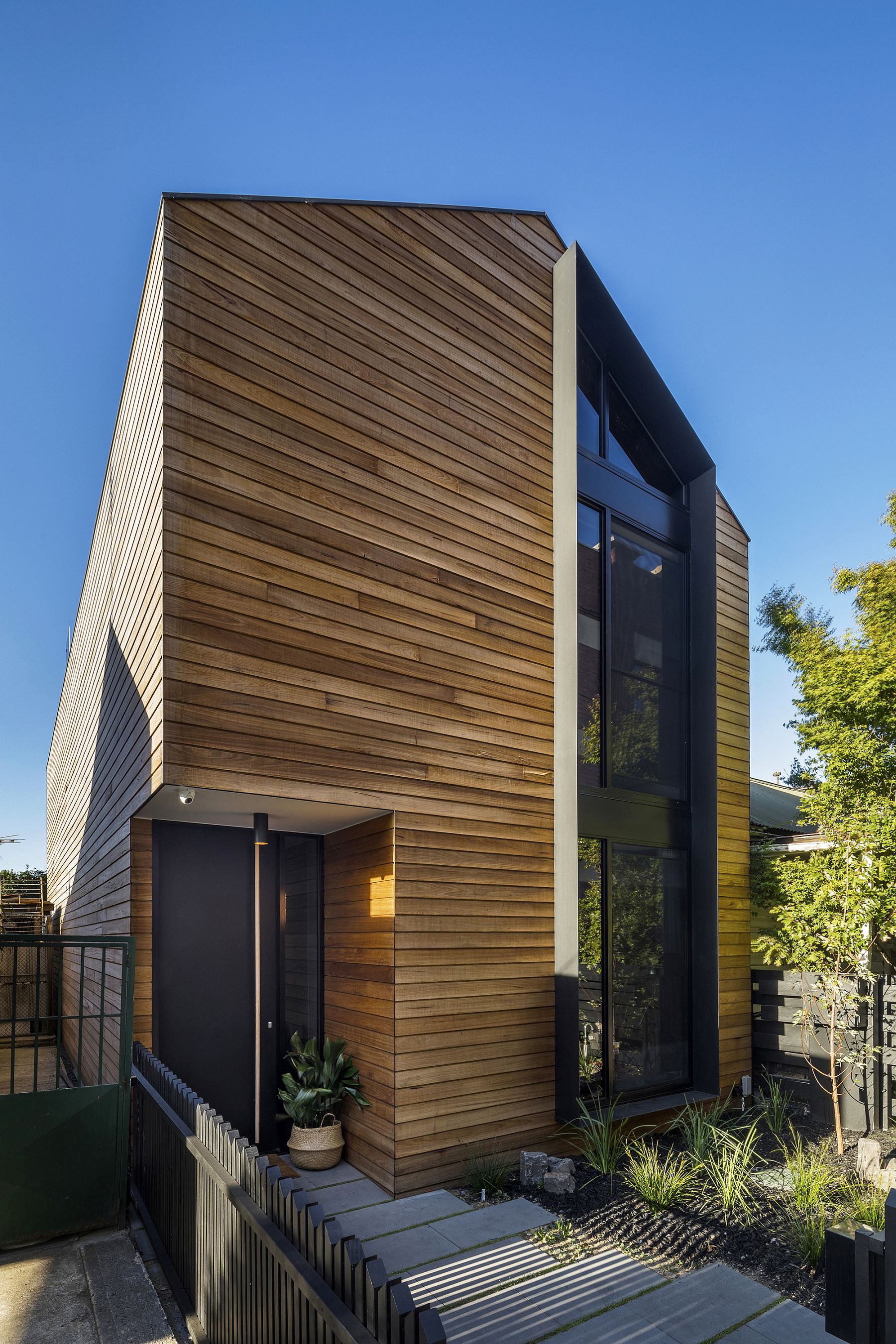 Wooden slats cover the street facade of the T2 Residence