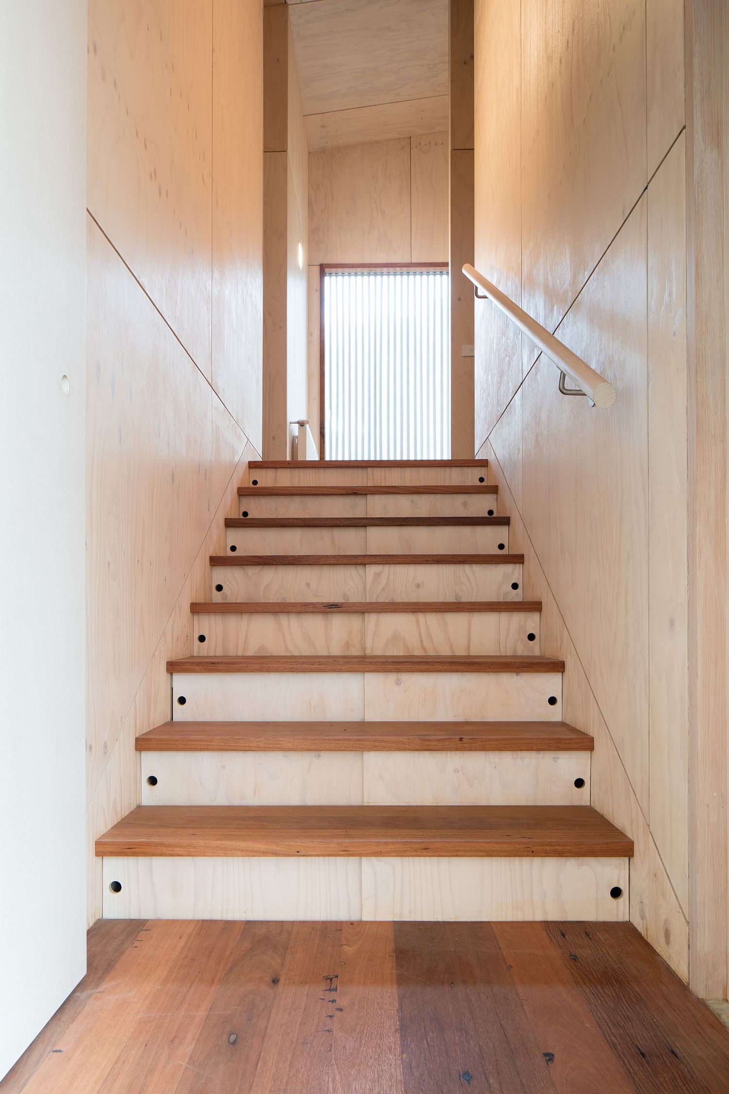 Wooden steps connecting different floors of the bushland home