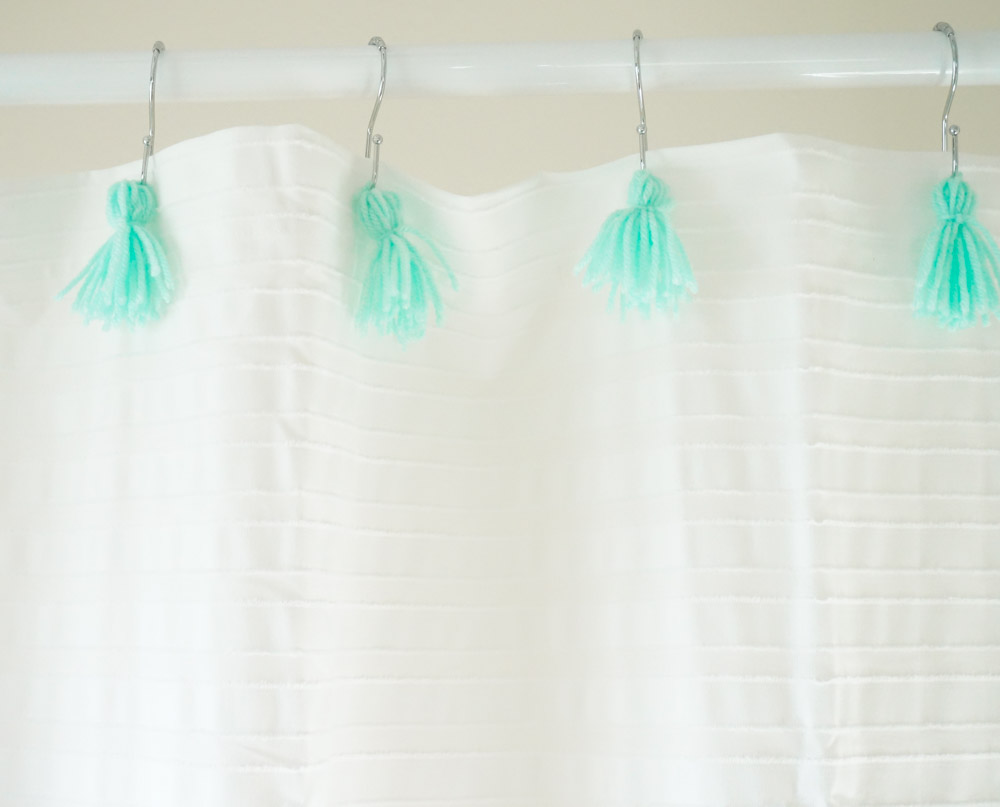 Aqua tassels on a white shower curtain
