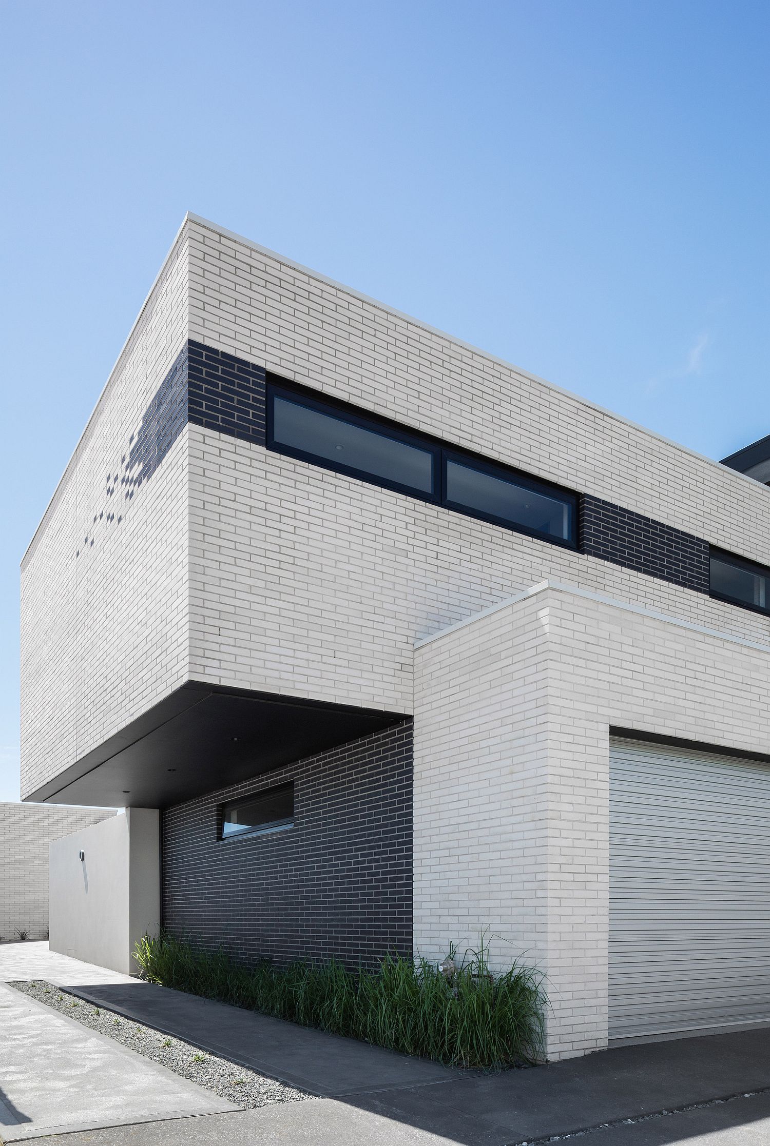 Bedroom on the upper level cantilevers above the garage