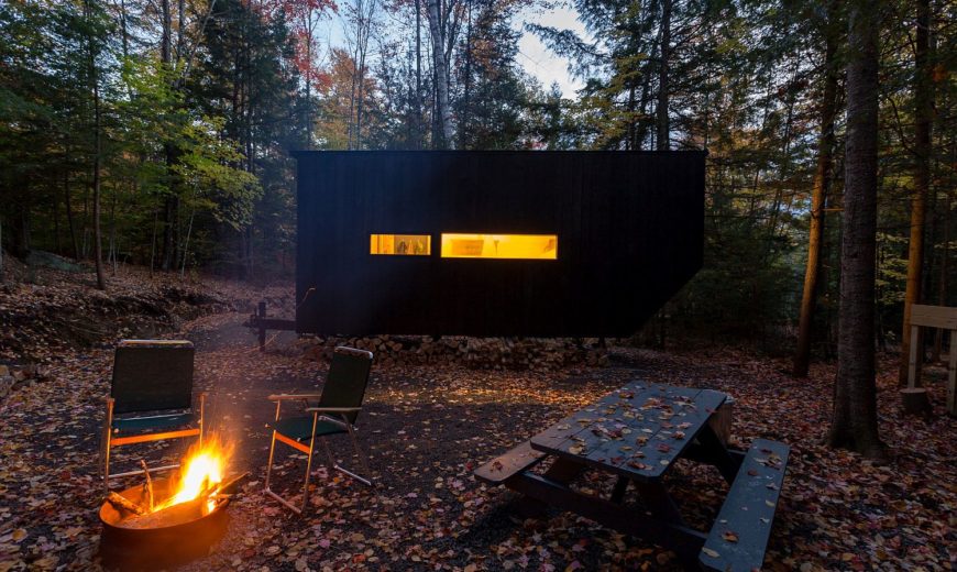 Tiny Cabin in the Woods Charms with Dark Exterior and Versatile Design
