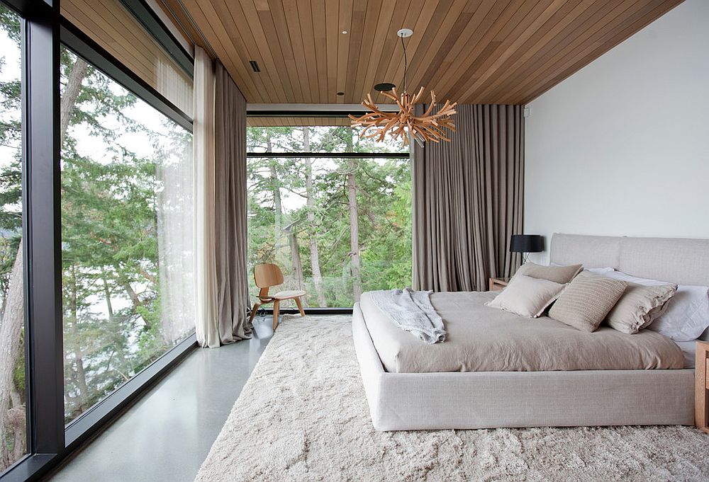 Ceiling and shutters add woodsy charm to this modern bedroom in white