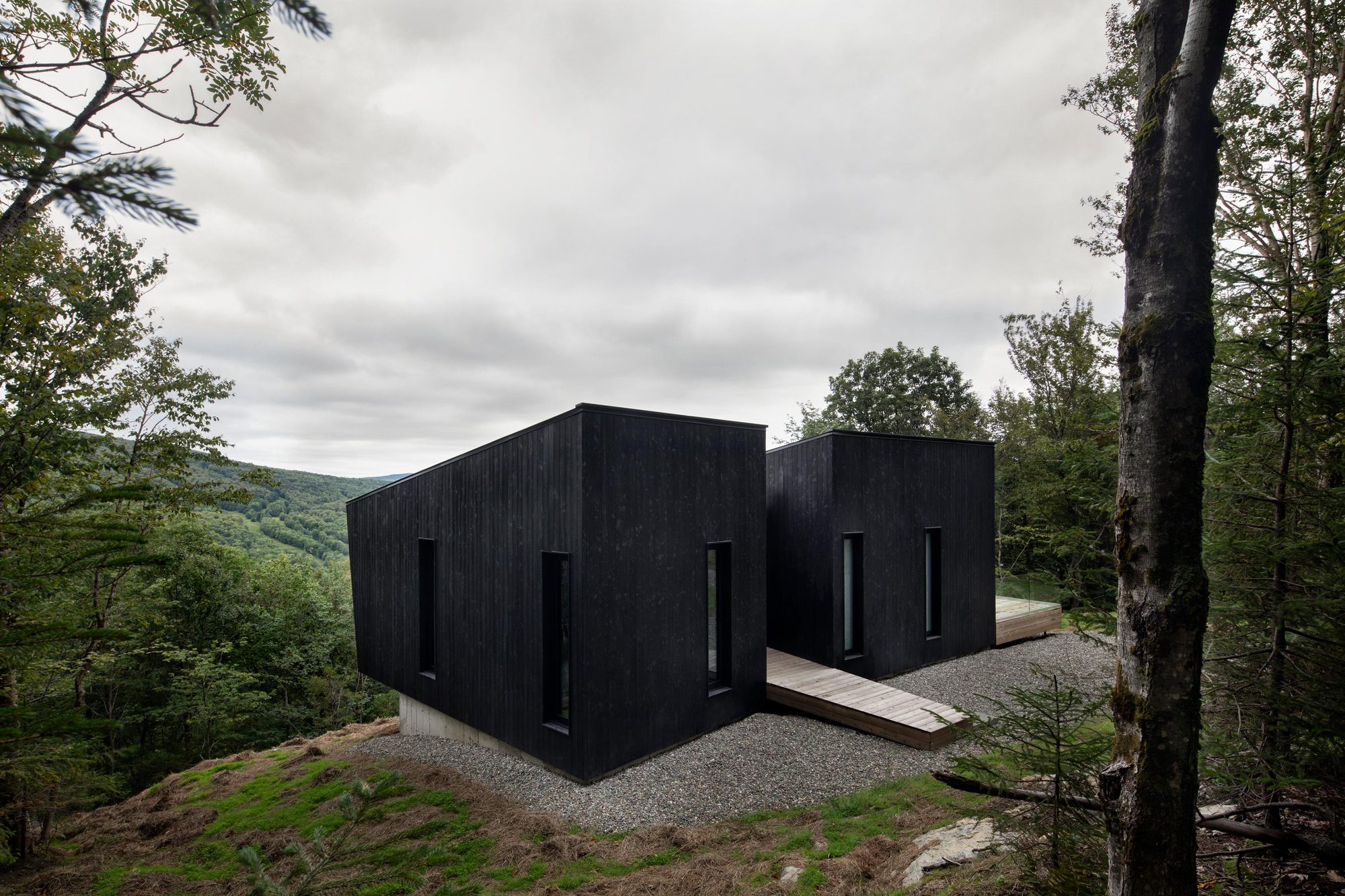 Dark burnt-wood facade of the cabin units