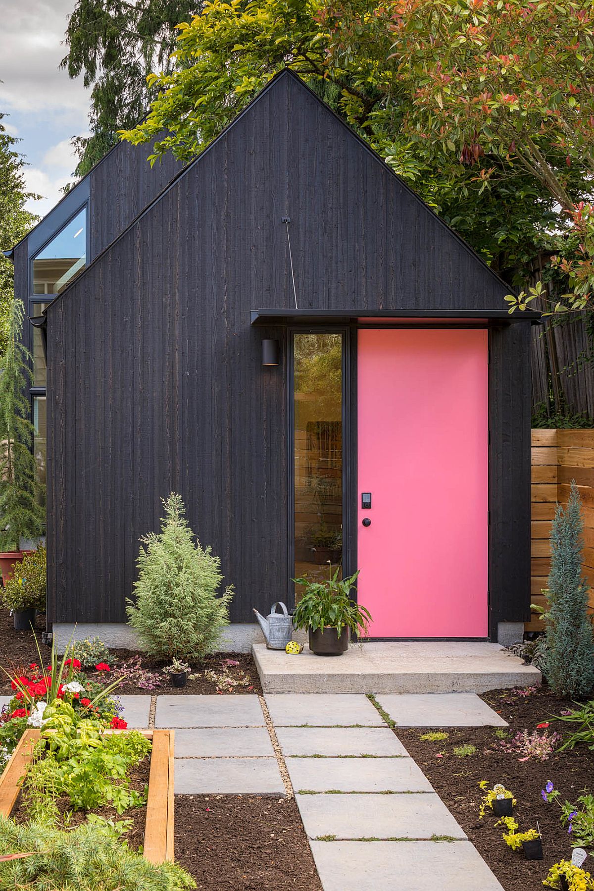 Dark-exterior-of-the-home-with-pink-door