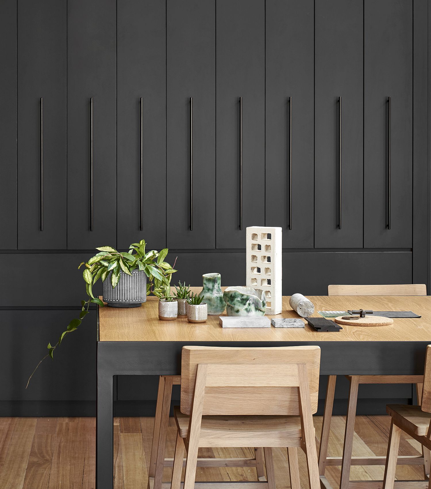 Dining area display with black backdrop and wooden dining table