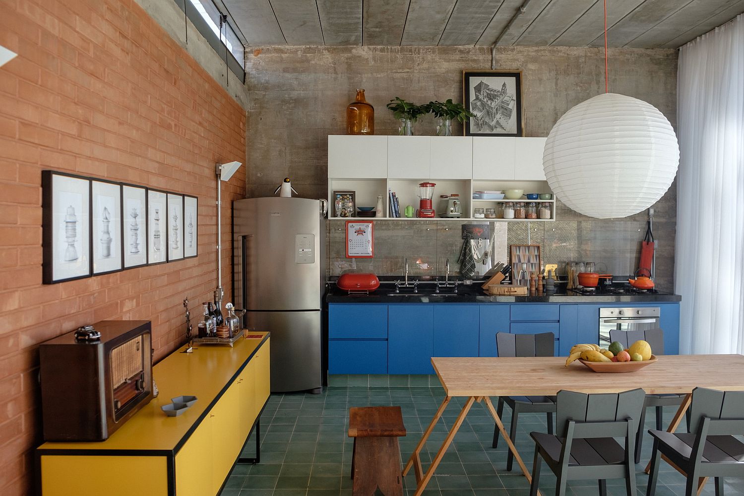 Exposed red brick and concrete shape a lovely living area