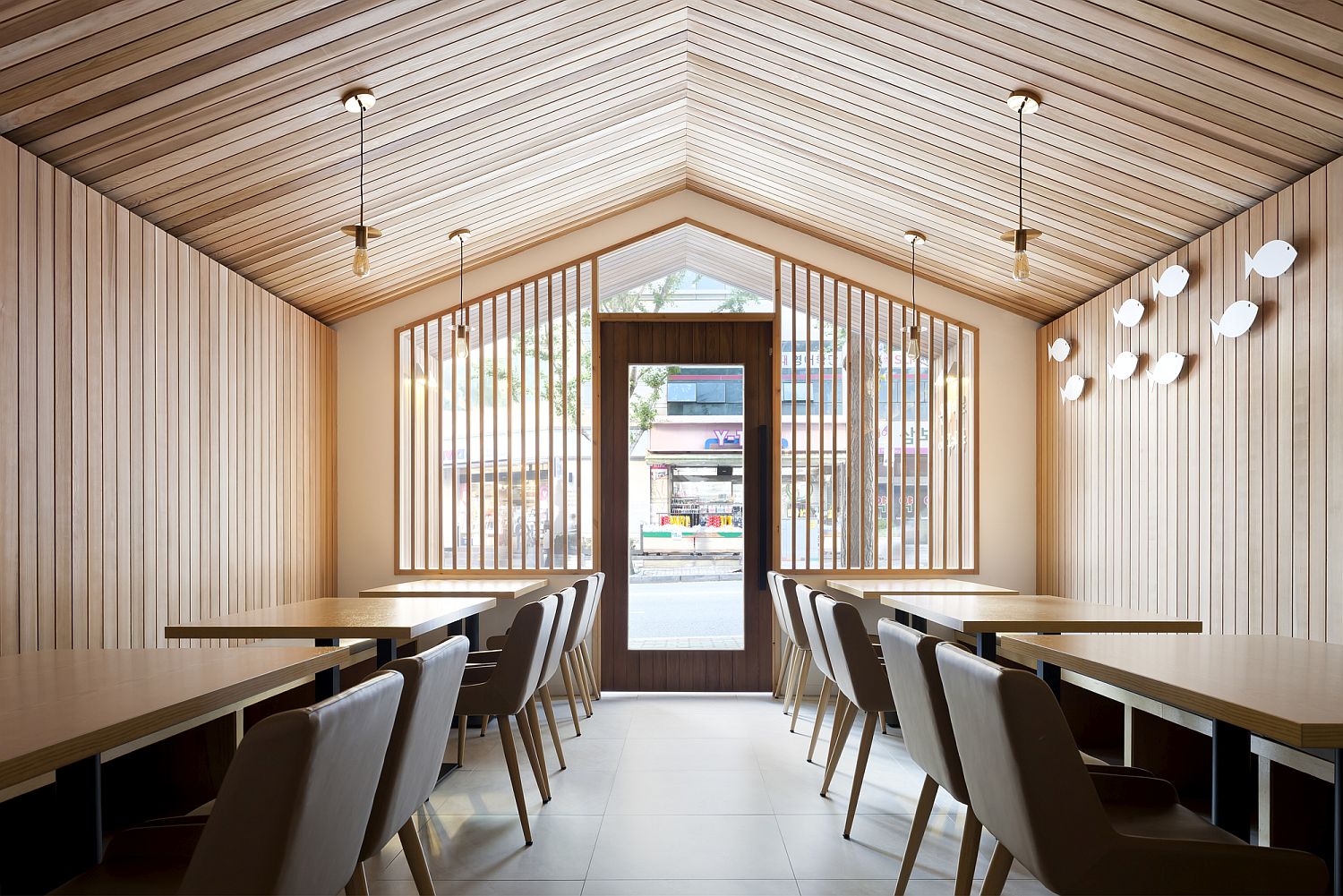 Gable roof and red cedar create a light-filled ambiance inside the small restaurant