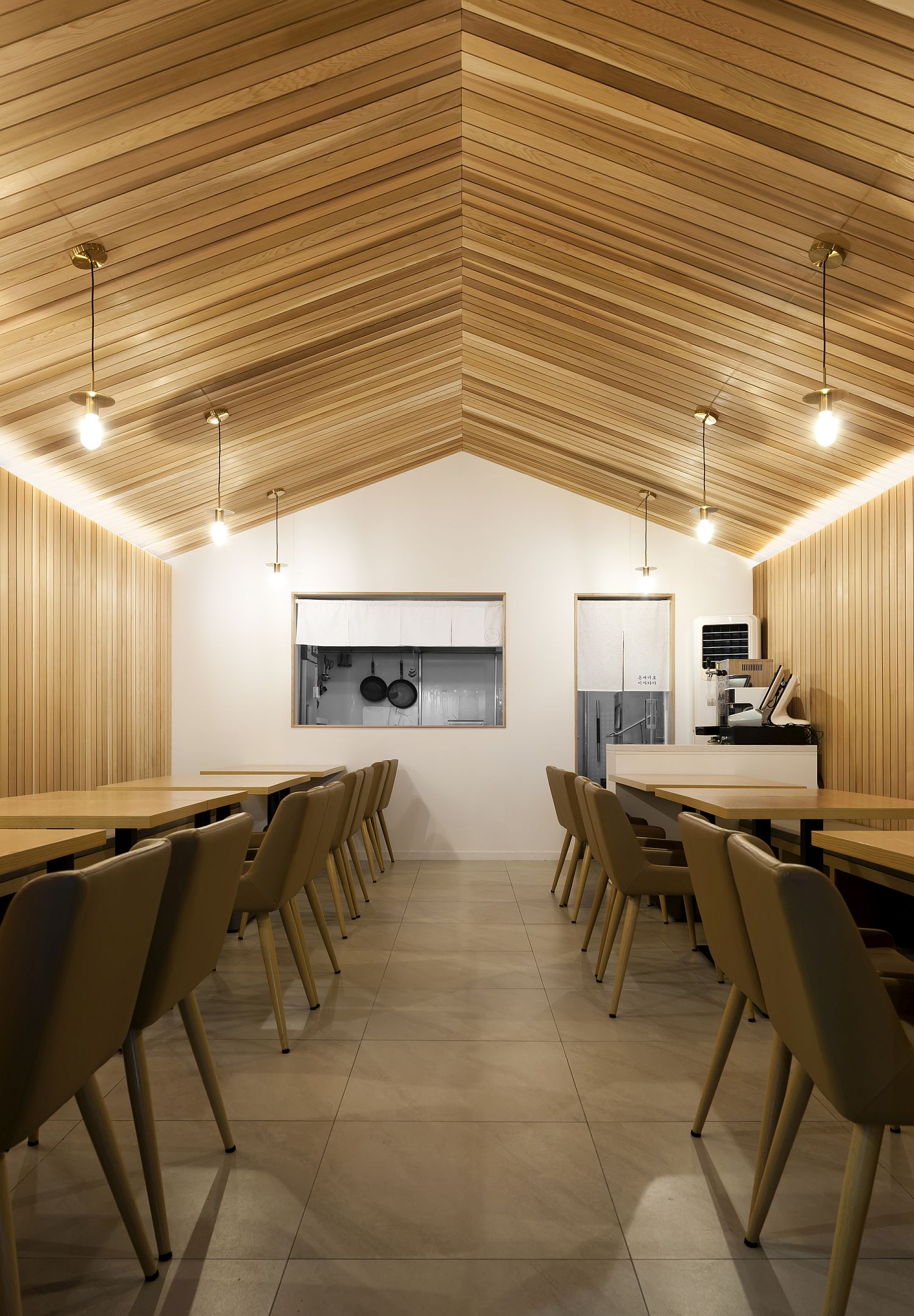 Gabled roof form creates more space visually inside the restaurant