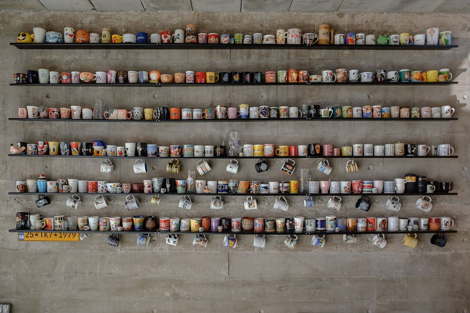 Gorgeous collection of mugs on slim floating shelves inside the Brazilian home