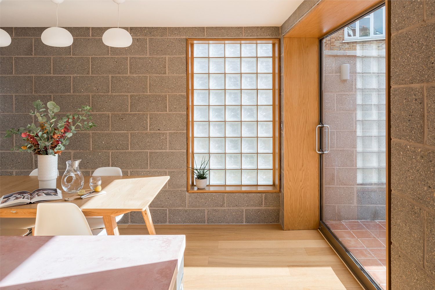 Gray cement blocks, and sand-blasted glass create a vivacious and bright interior