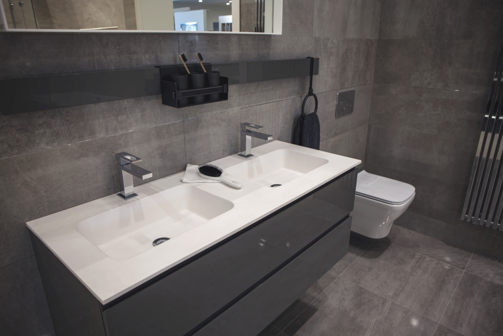 Grey modern bathroom with white wash basins for contrast