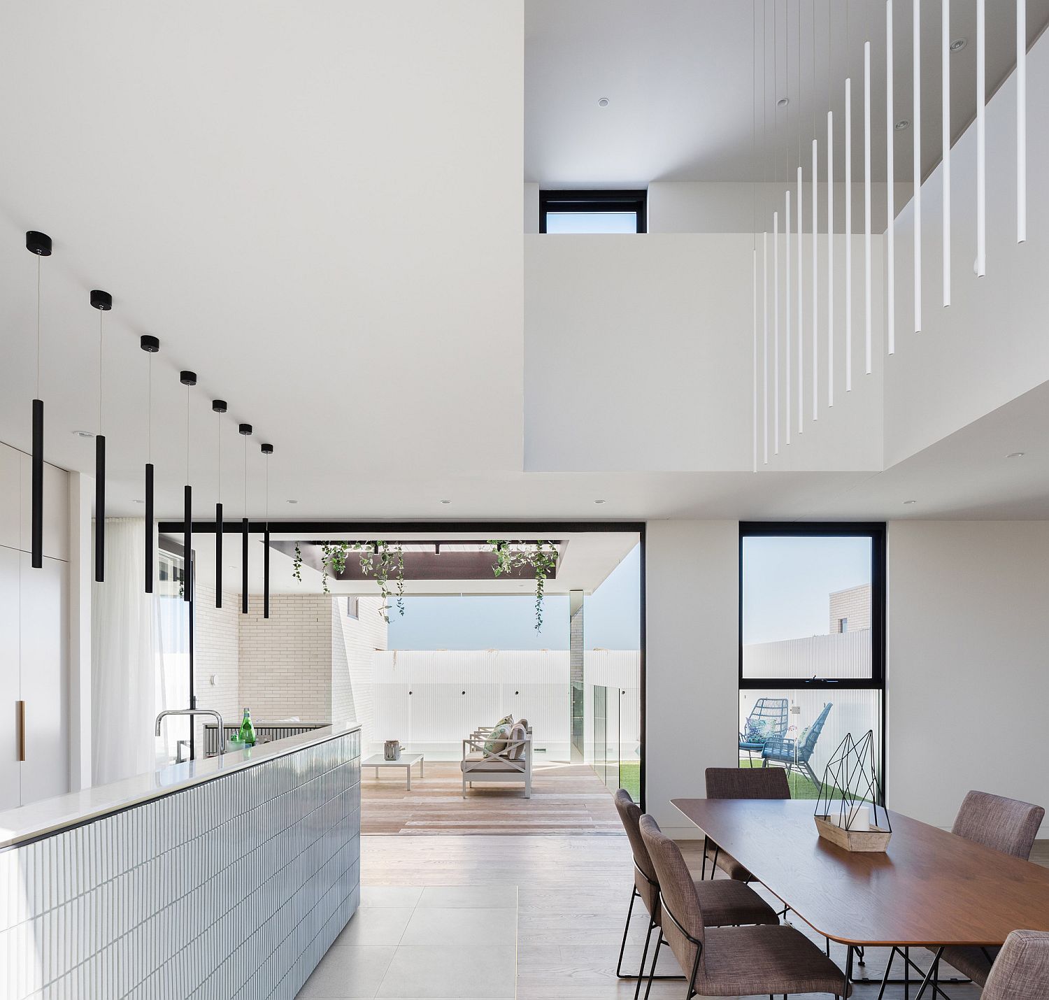 Light-filled dining area and kitchen of the Sydney home in white