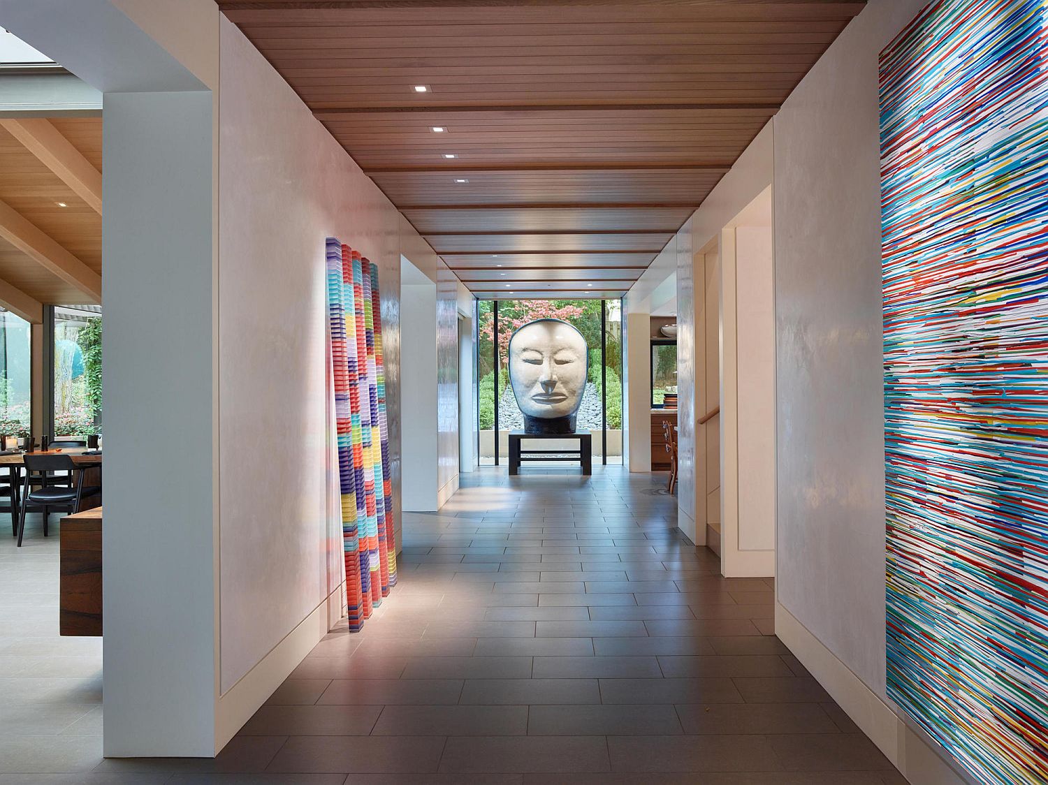 Light-filled interior of the home with colorful art installations