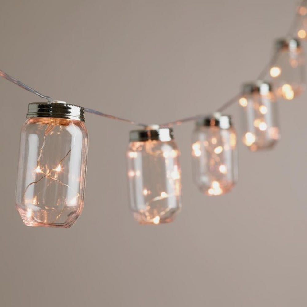 Mason jars coupled with string lights for a cool holiday lighting idea