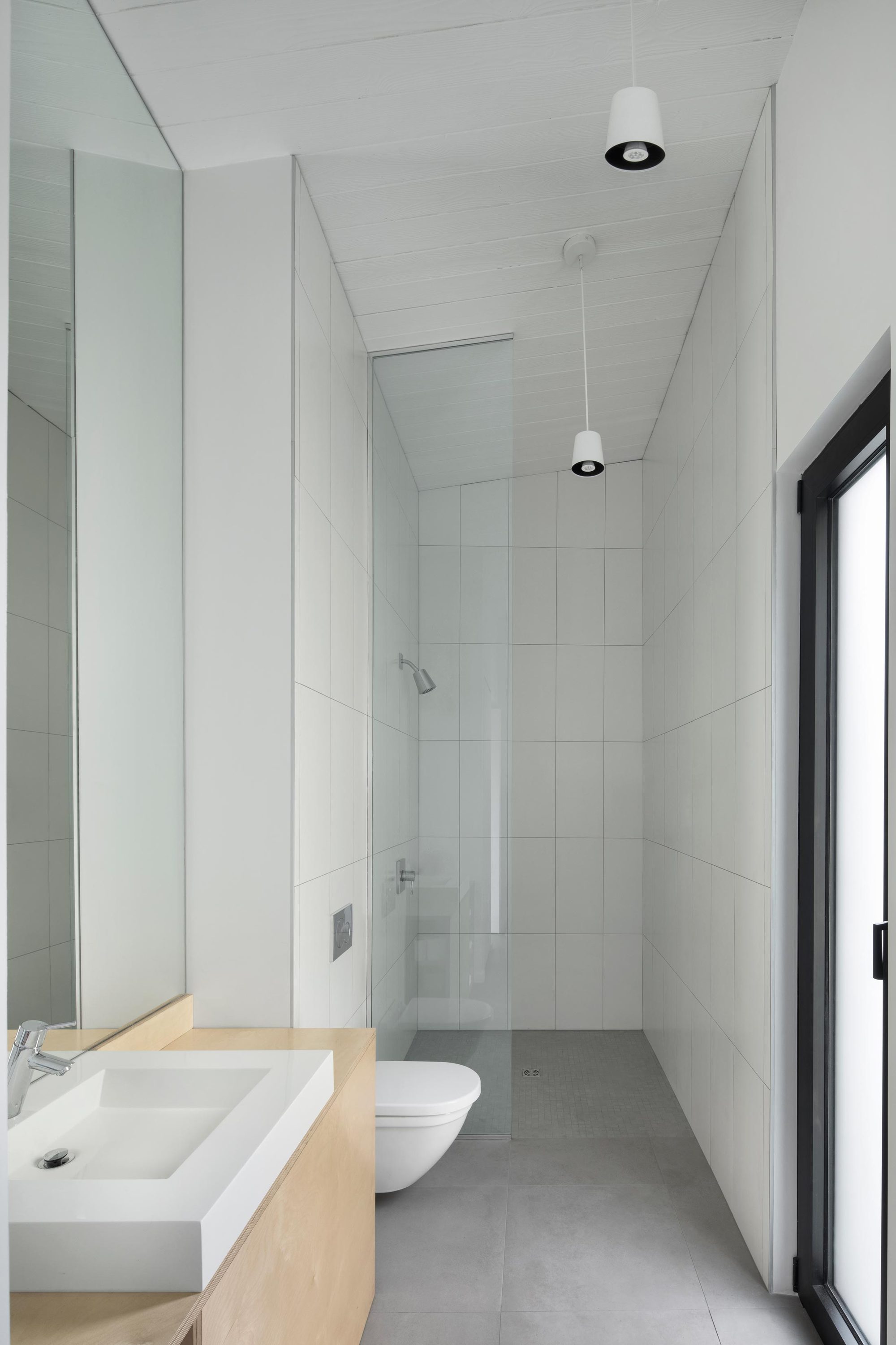 Minimal-bathroom-in-white-with-wooden-vanity