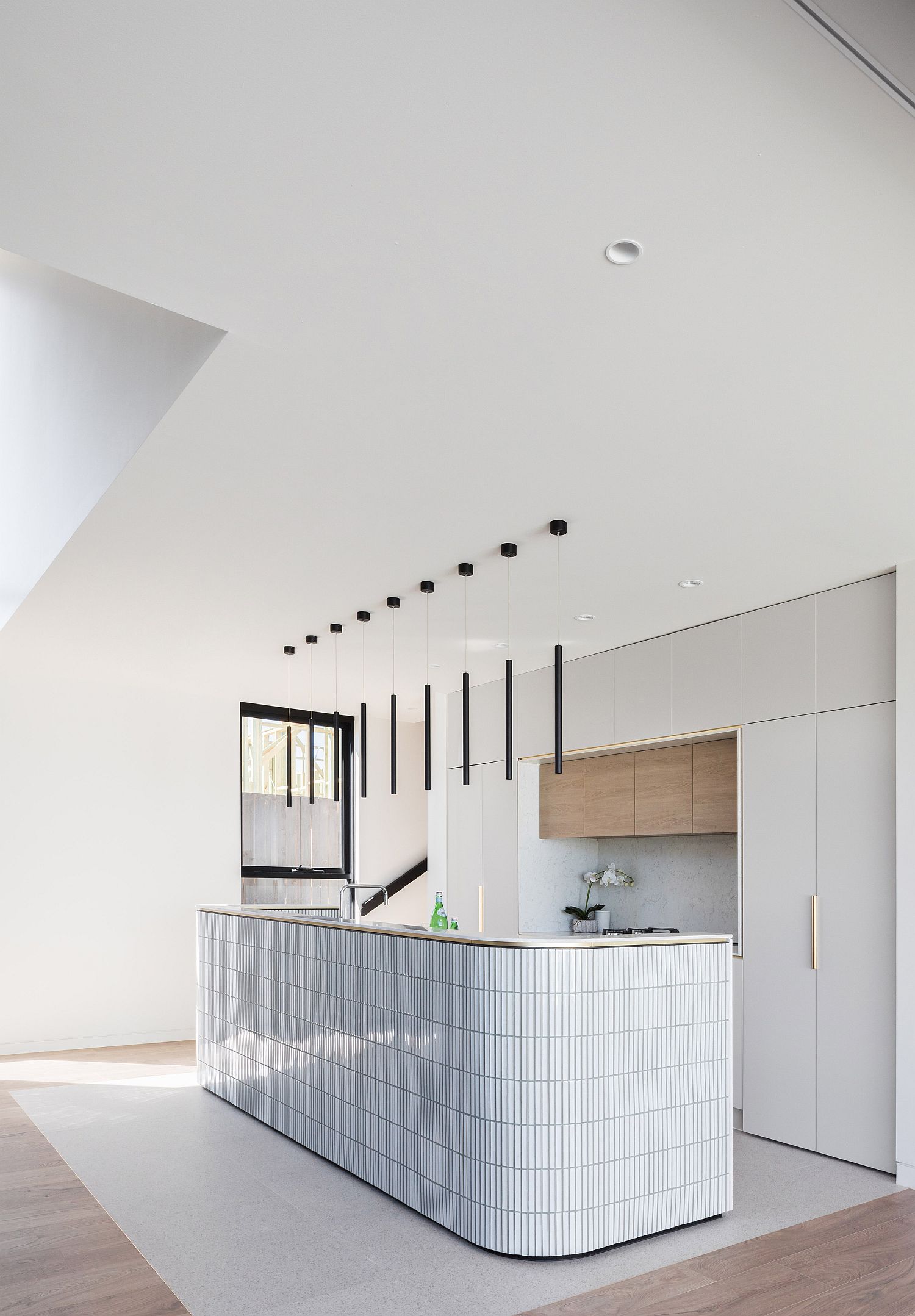 Minimal kitchen with curved island that is a showstopper