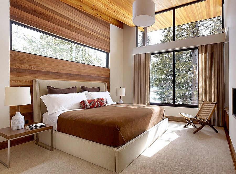 Minimalist bedroom in white with wooden accents and large glass windows