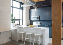 Painted-brick-wall-in-white-along-with-wood-and-grayish-blue-kitchen-section-for-the-small-loft-217x155