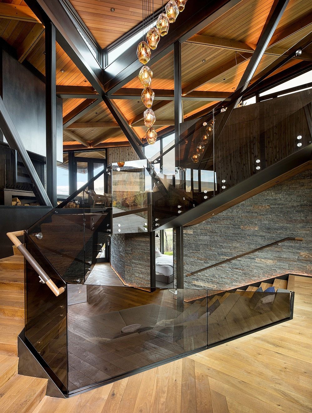 Polished glass and metal surfaces along with wooden warmth inside the house