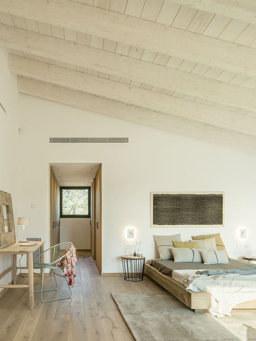 Relaxing-master-bedroom-in-white-and-wood-inside-modern-Spanish-home