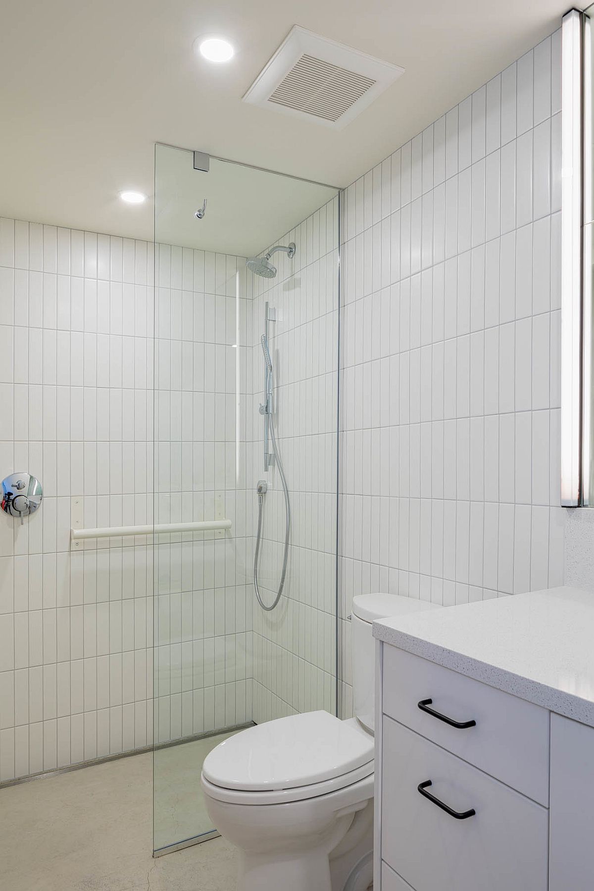 White bathroom with even lighting and modern aesthetics