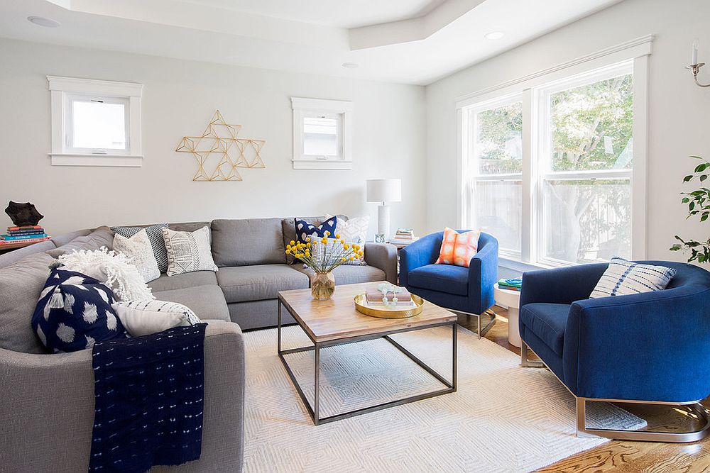 White living room with gray sectional and dashing blue club chairs