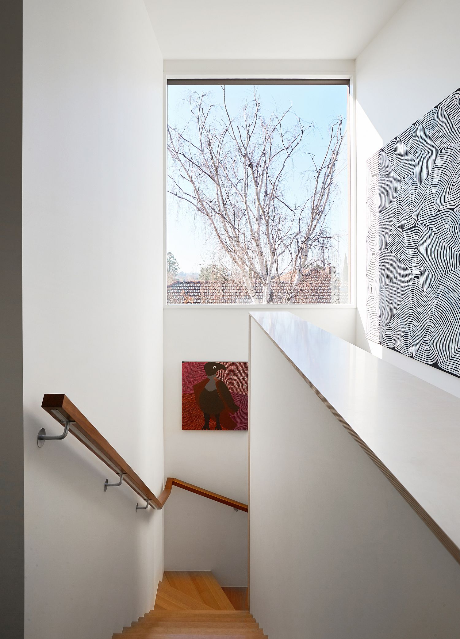 Window for the stairwell brings light into different levels of the house
