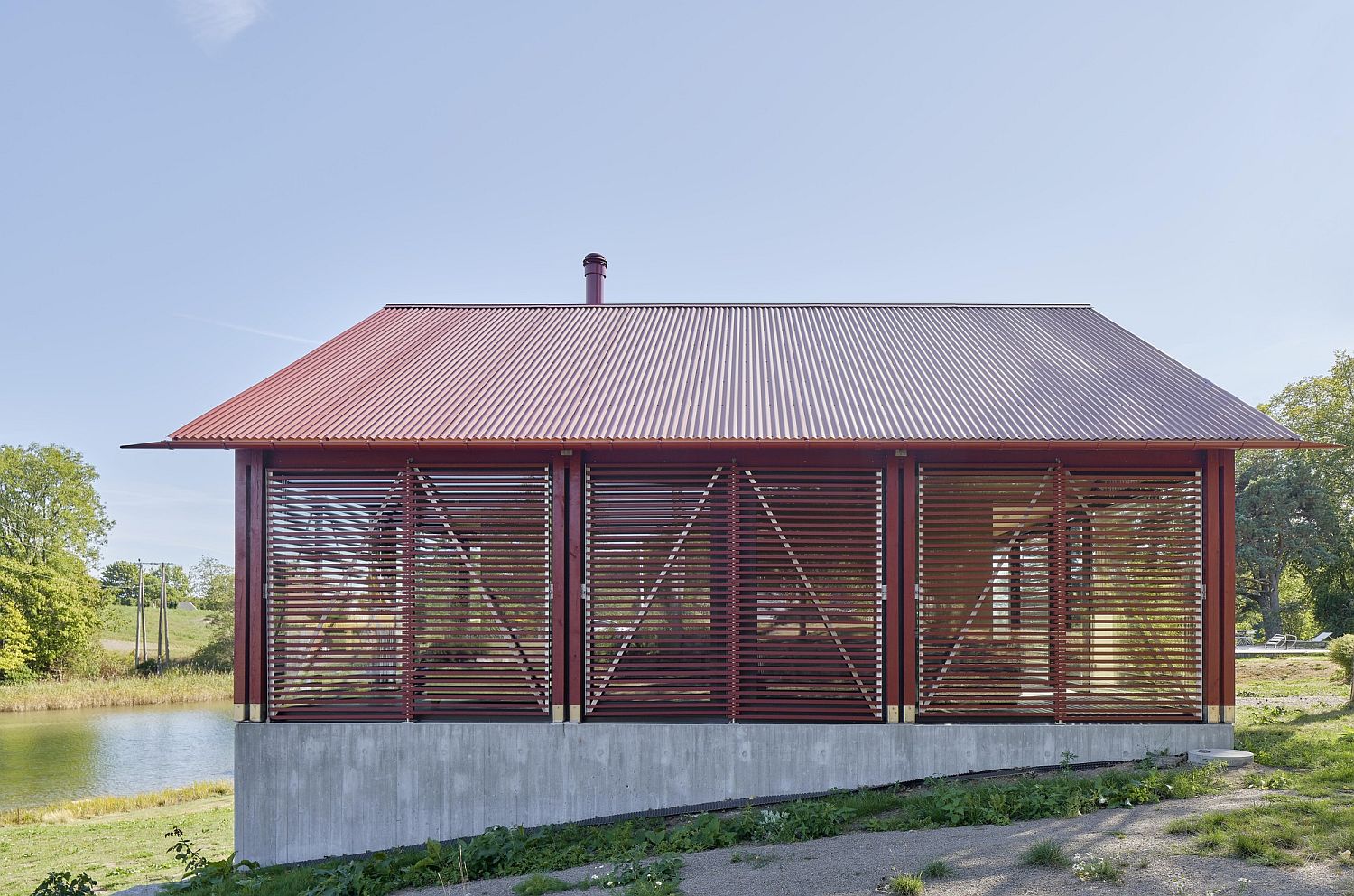 Wooden shutters and glass create the outer shell of the pavilion style cabin