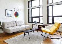 Yellow-recliner-coupled-with-light-gray-sofa-and-white-brick-wall-backdrop-in-the-living-space-217x155