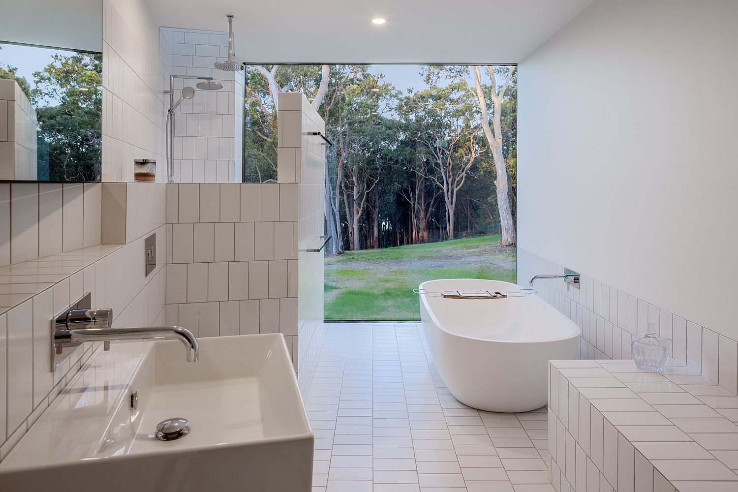 All-white bathroom connected to the garden outside