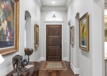 Art-gallery-style-entry-in-white-with-framed-art-work-on-the-walls-217x155