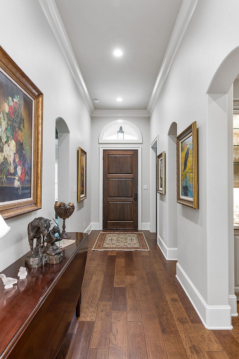 Art gallery-style entry in white with framed art work on the walls