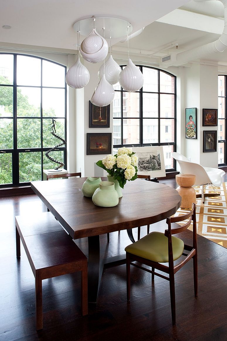 Both the dining table and the pendants move away from the mundane here