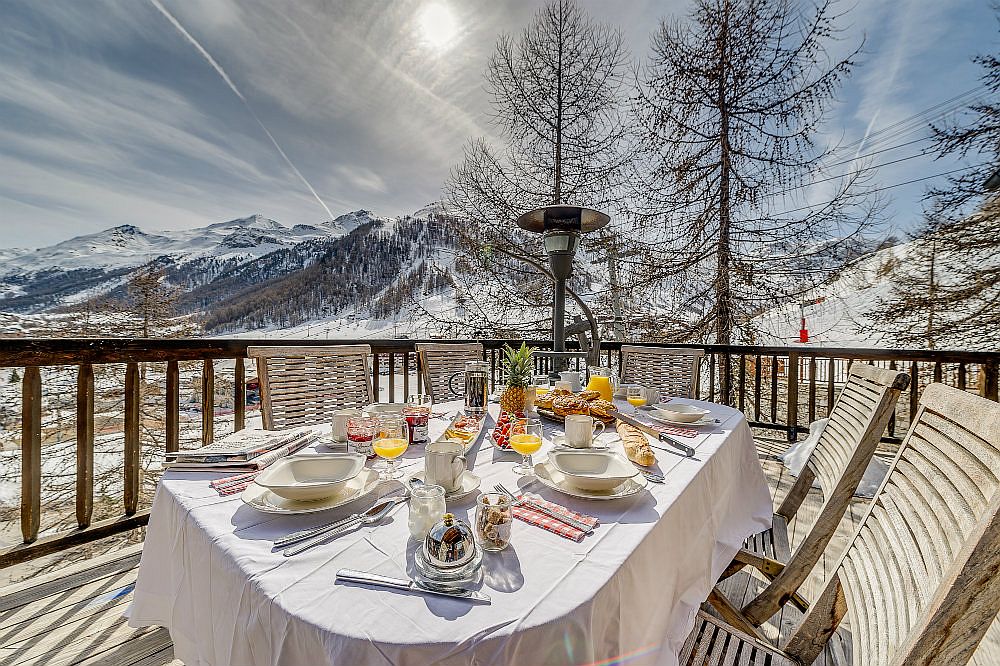 Breathtaking view of Val d’Isère and the snow-covered Alps from the terrace of the chalet