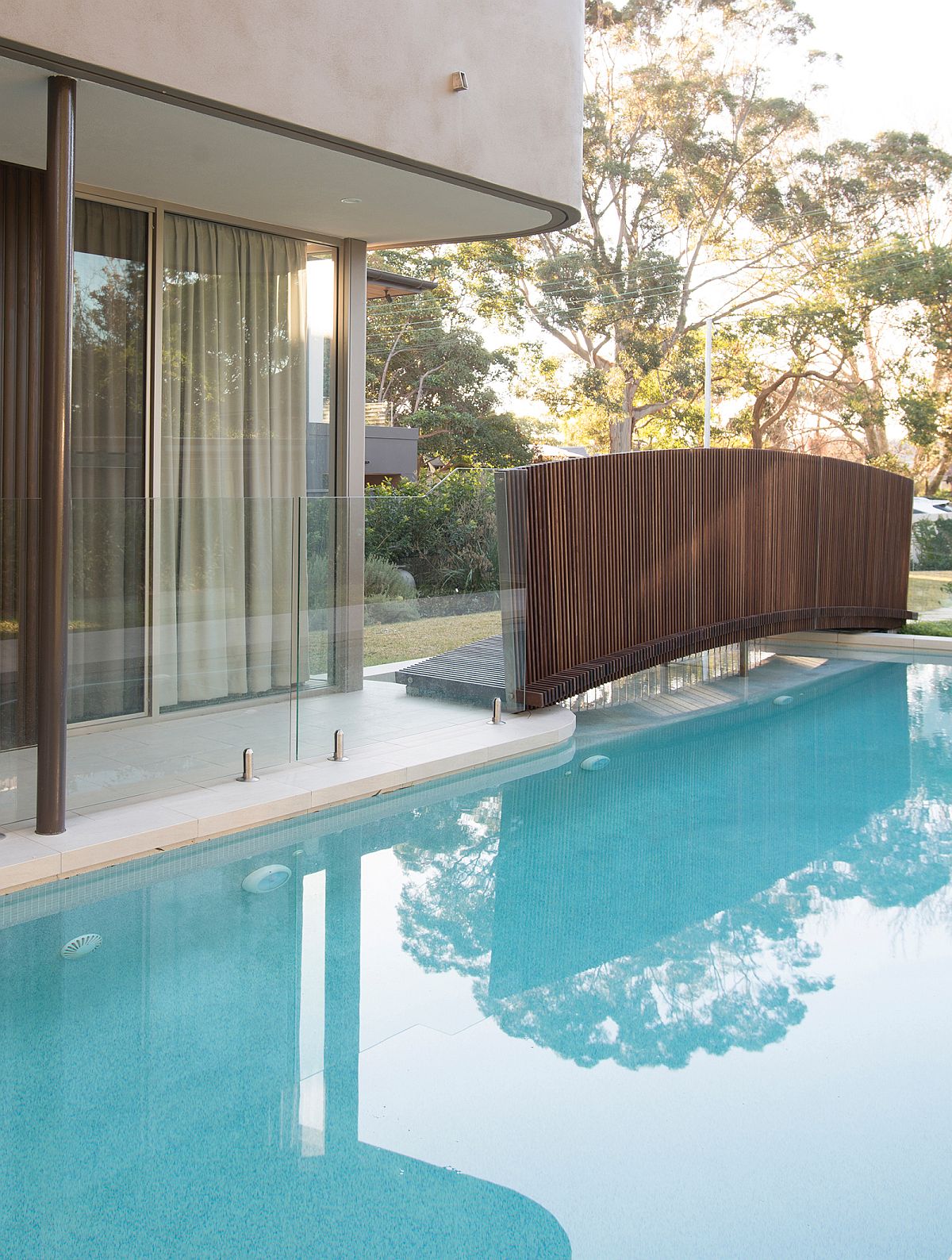 Bridge above pool offers access to the entry of the house