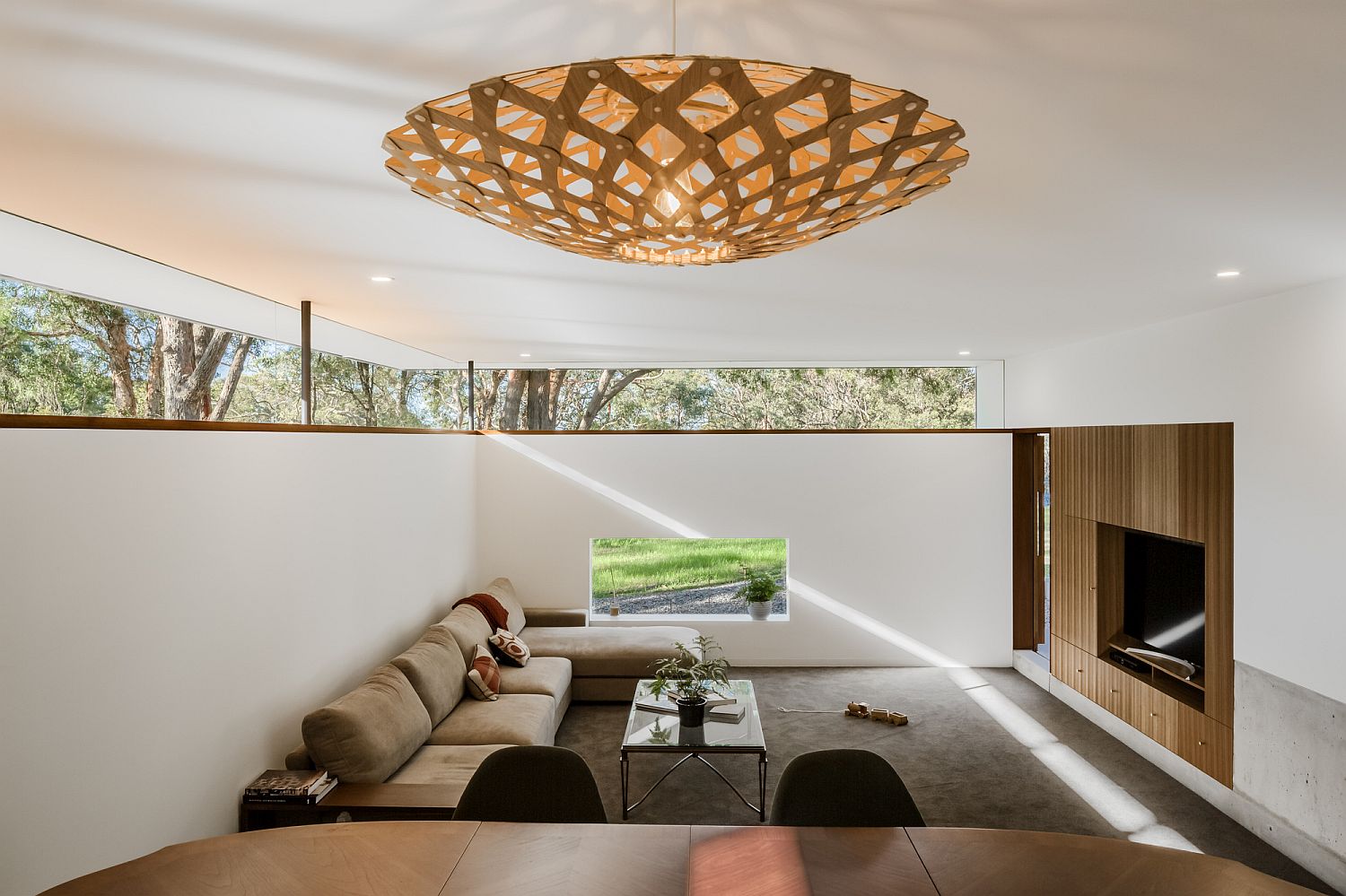 Clerestory windows bring brightness into the sitting area and the workspace