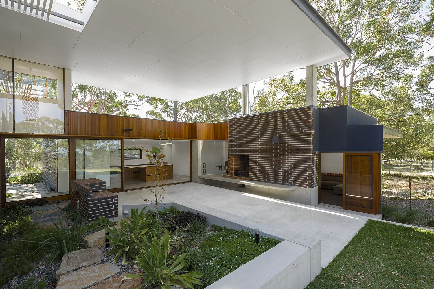 Covered exterior spaces flow into the natural landscape outside