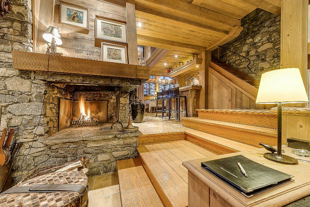 Cozy stone fireplace in the large living area that can accomodate 15 guests with ease