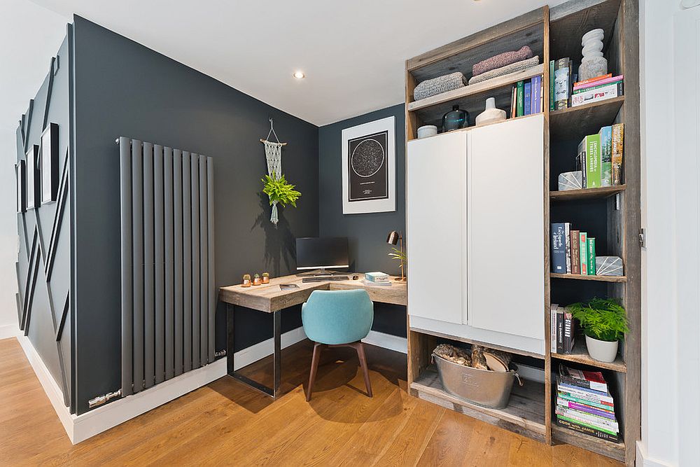 Dark gray home office with corner desk in wood and custom shelving