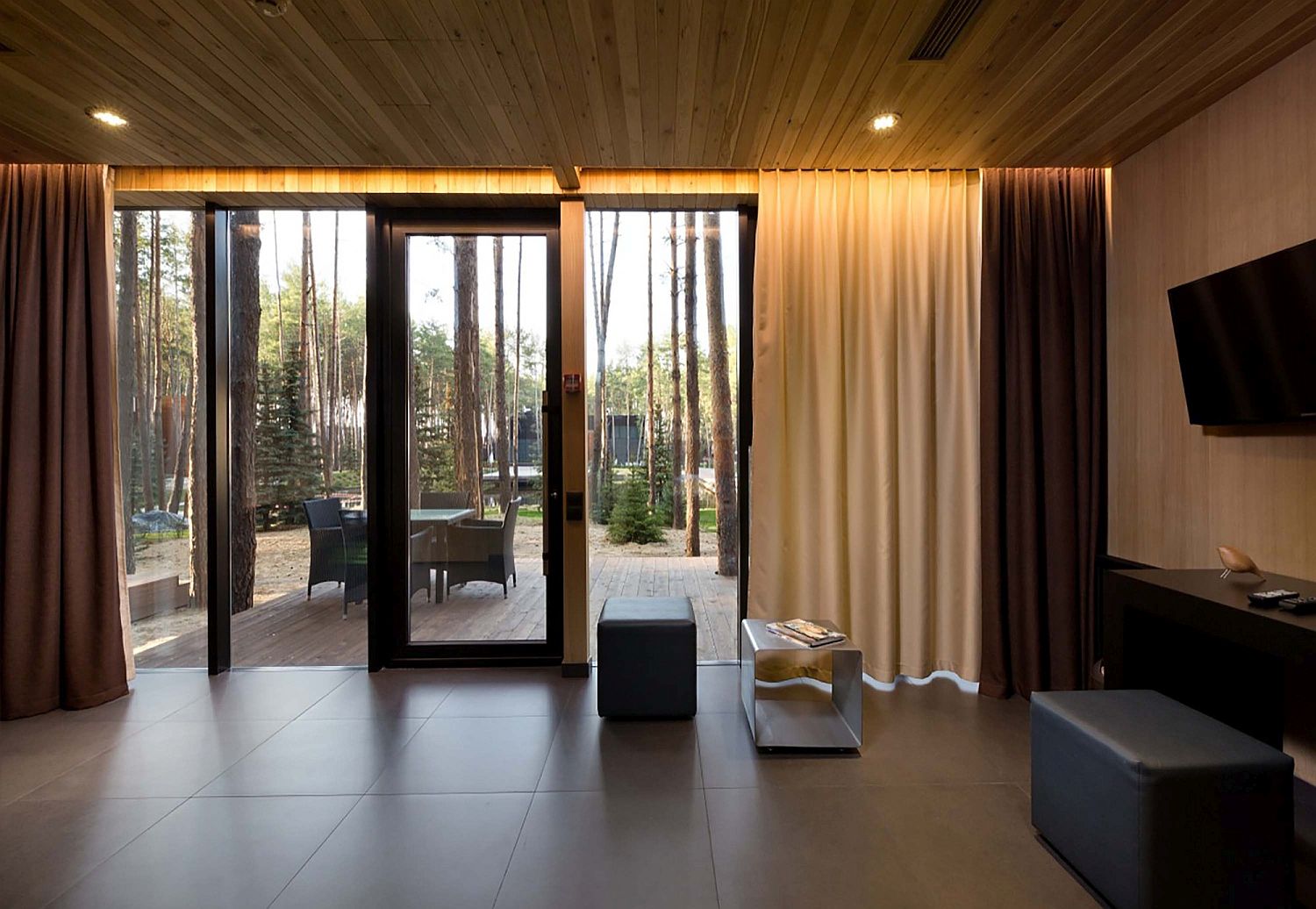 Drapes, heated floors and woodsy interior provide a cozy living space