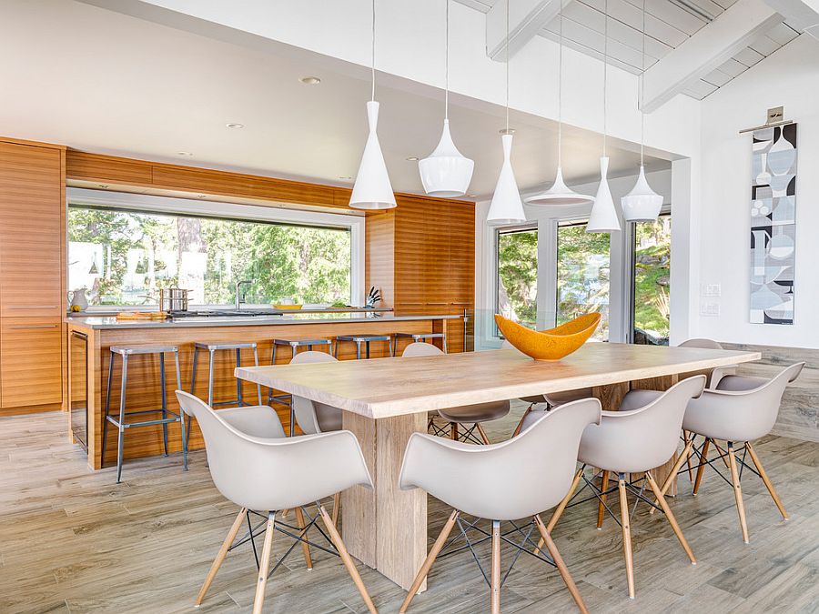 Geometric contrast takes over with lighting fixtures in this dining space