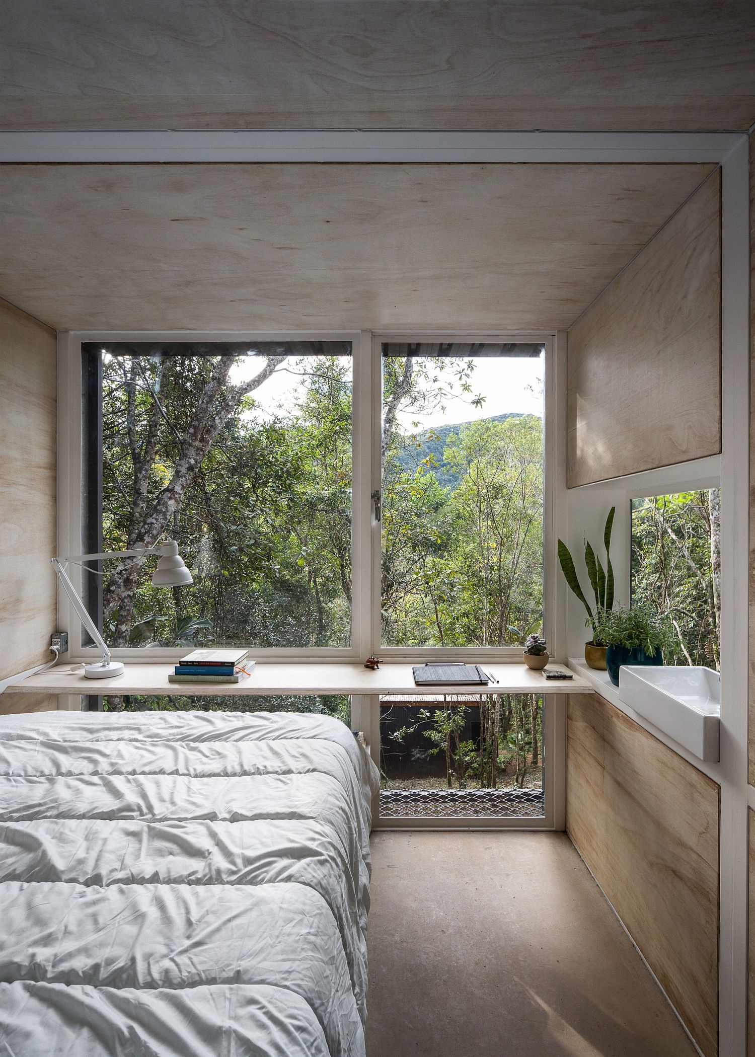 Interior-with-a-desk-bed-and-sink-keeps-things-down-to-a-minimum