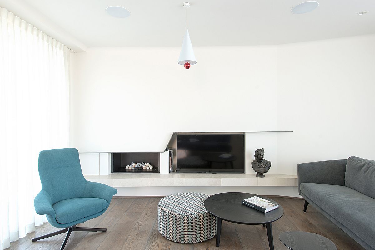 Living-room-in-white-with-gray-couch-and-bright-blue-lounger