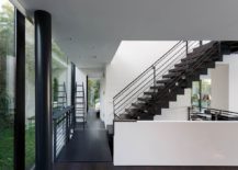 Metal-glass-and-polished-white-surfaces-shape-the-interior-of-the-Lake-House-217x155