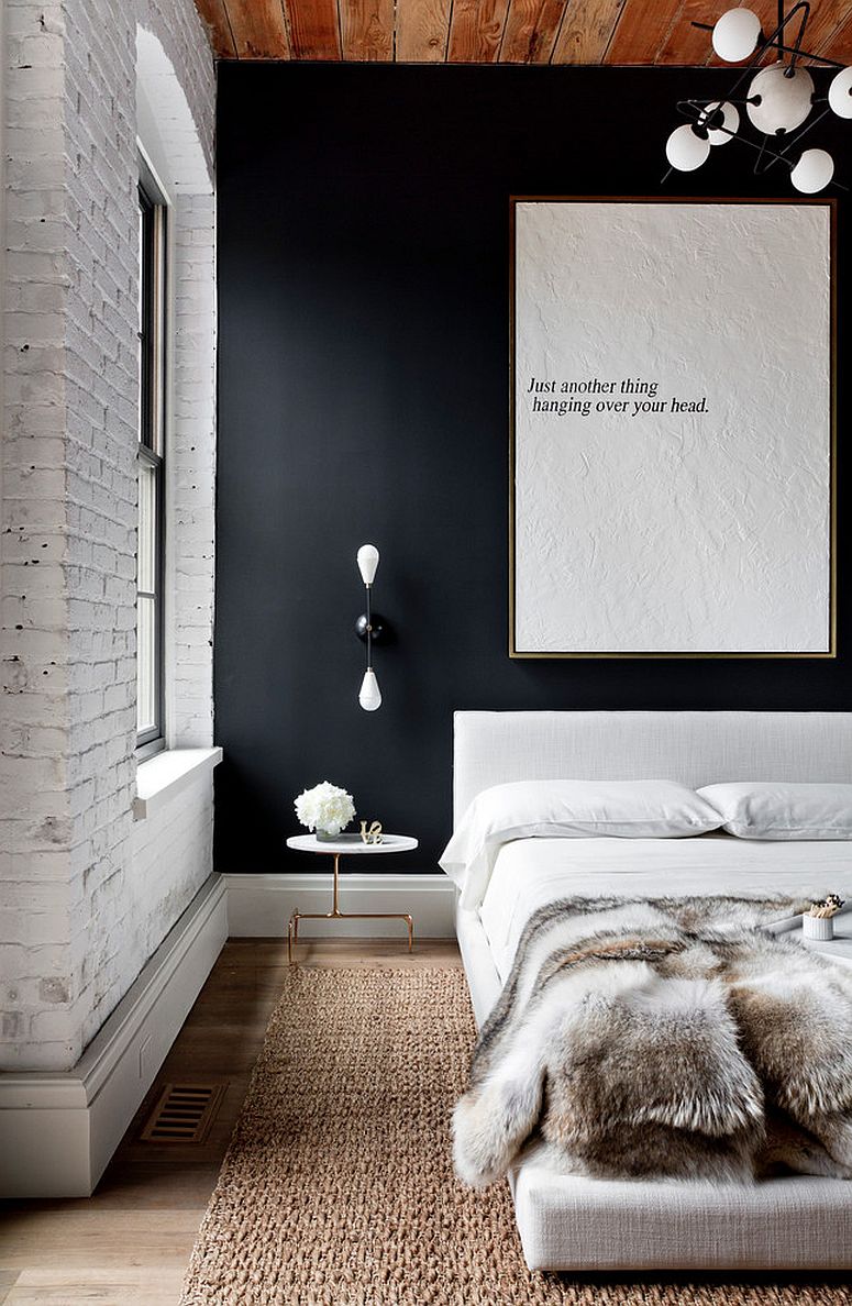 Modern industrial bedroom with whitewashed brick walls and black accent wall