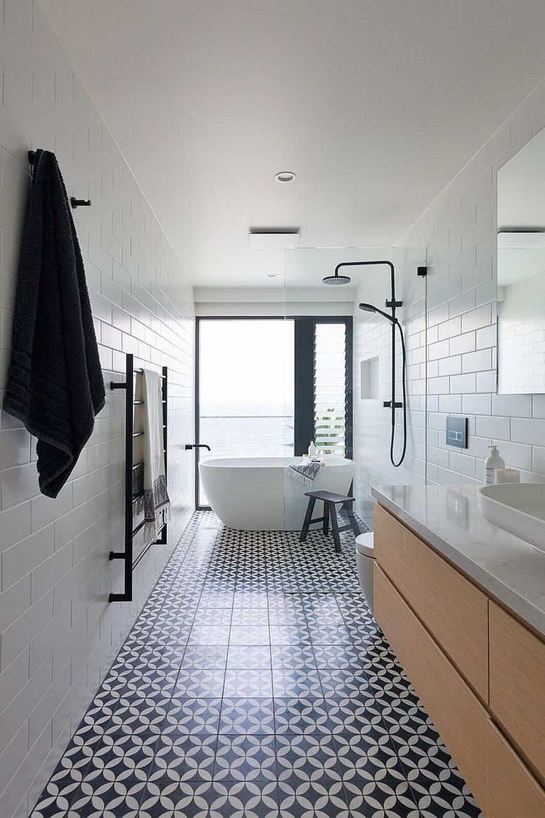 Narrow-white-bathroom-with-wooden-vanity-and-floor-with-pattern